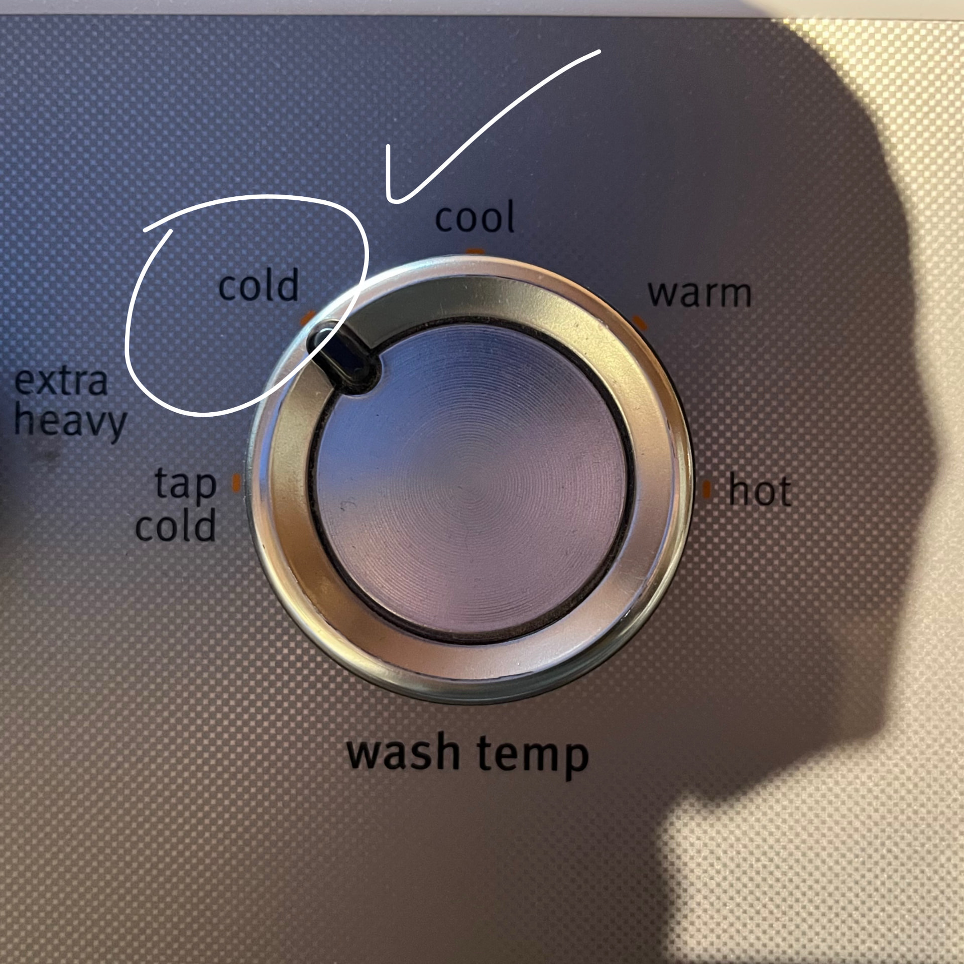 Washer temperature dial set to cold, with cold circled as the recommended setting